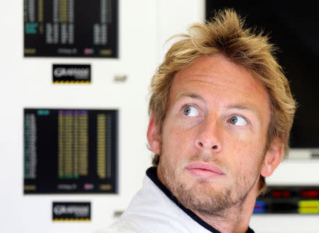 FILE PHOTO - Brawn GP Formula One driver Jenson Button of Britain looks at a screen during the first free practice session ahead of the weekend's Belgian F1 Grand Prix in Spa Francorchamps August 28, 2009. REUTERS/Yves Herman/File Photo