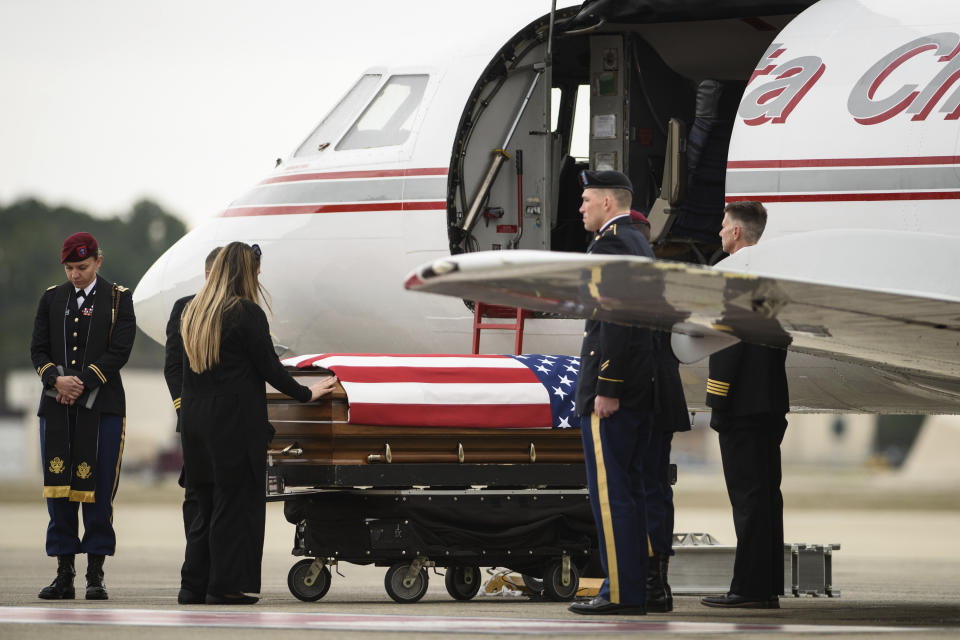 Tarah McLaughlin, the widow of Staff Sgt. Ian Paul McLaughlin, touches her husband's coffin on Saturday, Jan. 18, 2020, on Fort Bragg, N.C. McLaughlin was killed Jan. 11 in Afghanistan. (Andrew Craft /The Fayetteville Observer via AP)