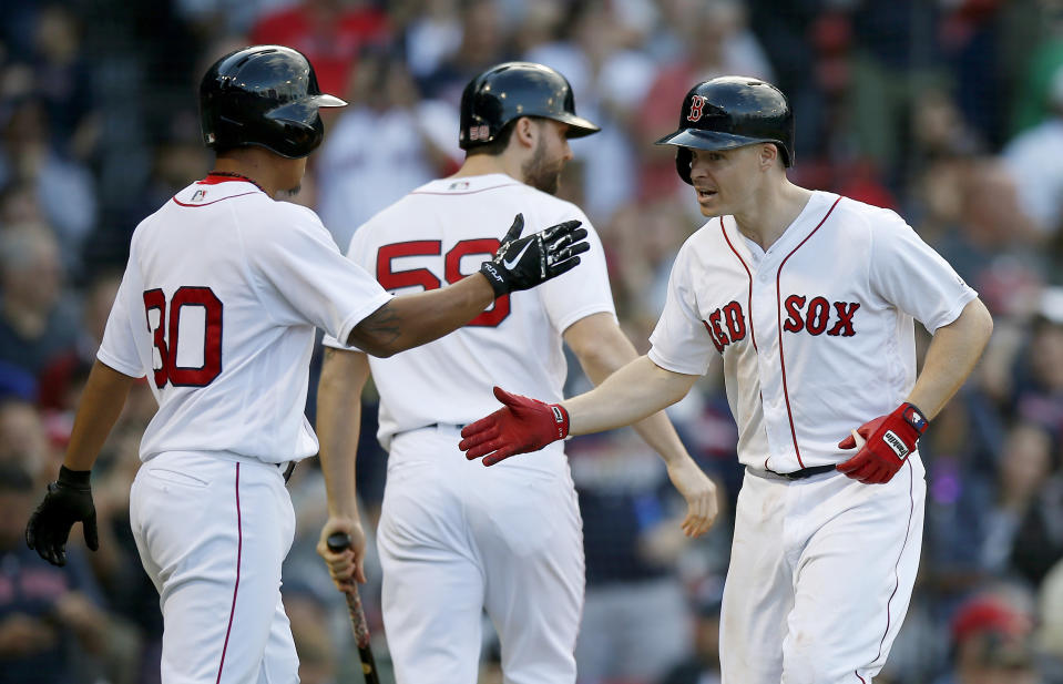 Boston Red Sox's Brock Holt, right, celebrates his two-run home run that also drove in Tzu-Wei Lin (30) during the ninth inning of a baseball game against the New York Yankees in Boston, Saturday, Sept. 29, 2018. (AP Photo/Michael Dwyer)