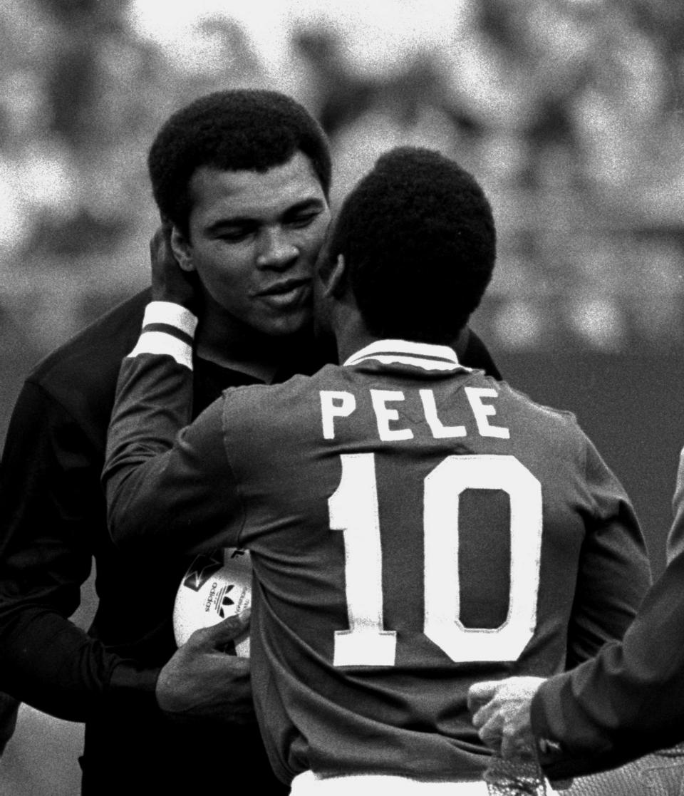 FILE - Soccer player Pele embraces boxer Muhammad Ali during a ceremony honoring the Brazilian soccer star of the New York Cosmos at Giants Stadium, East Rutherford, N.J., Oct. 1, 1977. Pelé, the Brazilian king of soccer who won a record three World Cups and became one of the most commanding sports figures of the last century, died in Sao Paulo on Thursday, Dec. 29, 2022. He was 82. (AP Photo/Richard Drew, File)
