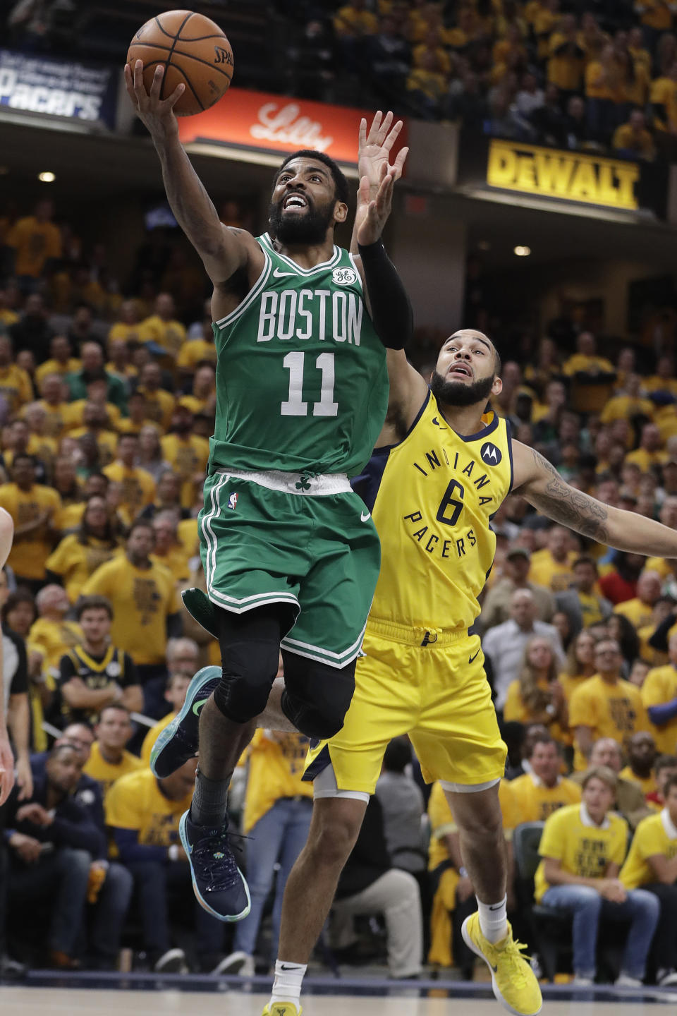 FILE - In this April 19, 2019, file photo, Boston Celtics' Kyrie Irving (11) shoots against Indiana Pacers' Cory Joseph (6) during the second half of Game 3 of an NBA basketball first-round playoff series in Indianapolis. Rarely relevant at the same time on the basketball court, the Knicks and Nets are front and center in the free agency race, two of the teams best positioned to make a splash when the market opens. Both can afford two top players, with hopes of landing not only a Kevin Durant or Kyrie Irving, but possibly even both. (AP Photo/Darron Cummings, File)
