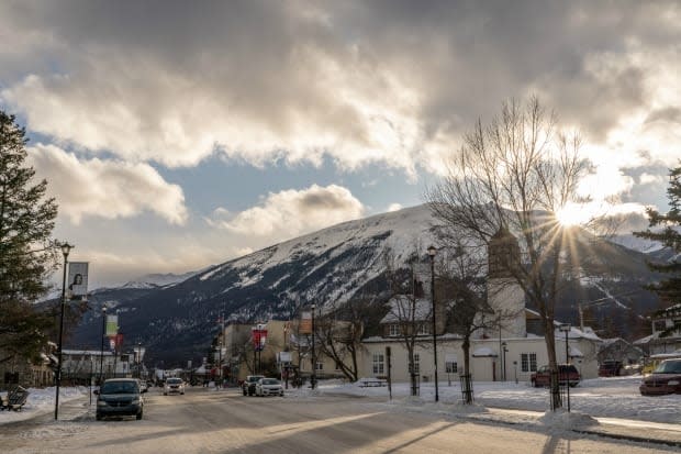 The sun peeks over a mountain in Jasper in this May 2020 file photo. The area is under a winter storm warning.  (Vincent Bonnay/Radio-Canada - image credit)