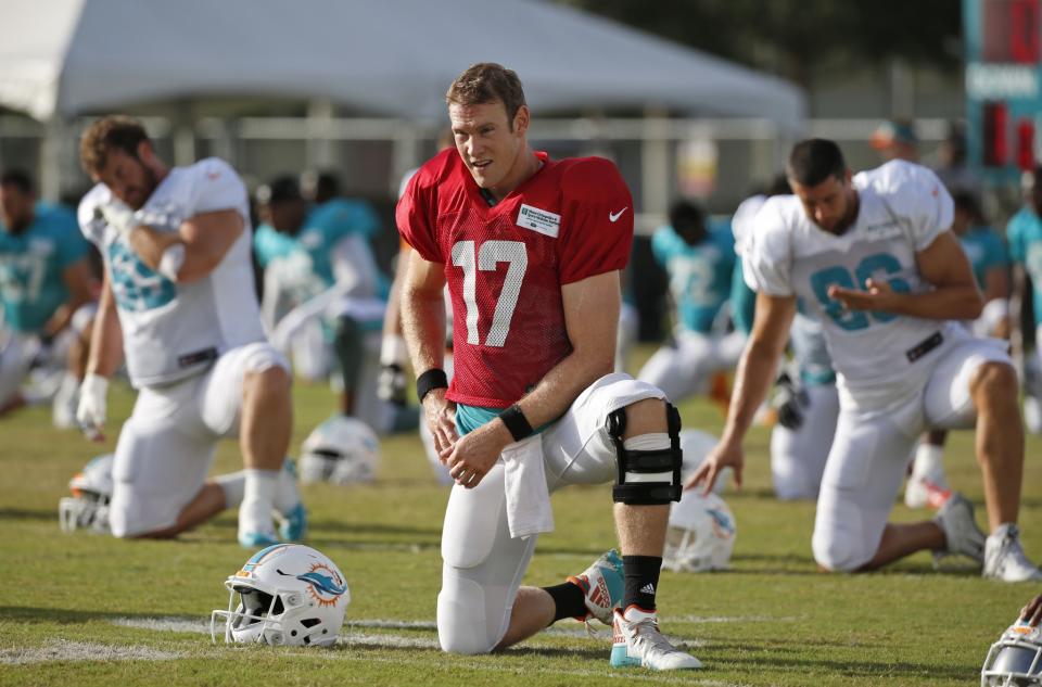 Not what they knee-d: Dolphins QB Ryan Tannehill left Thursday's practice with an apparent knee injury. (AP)
