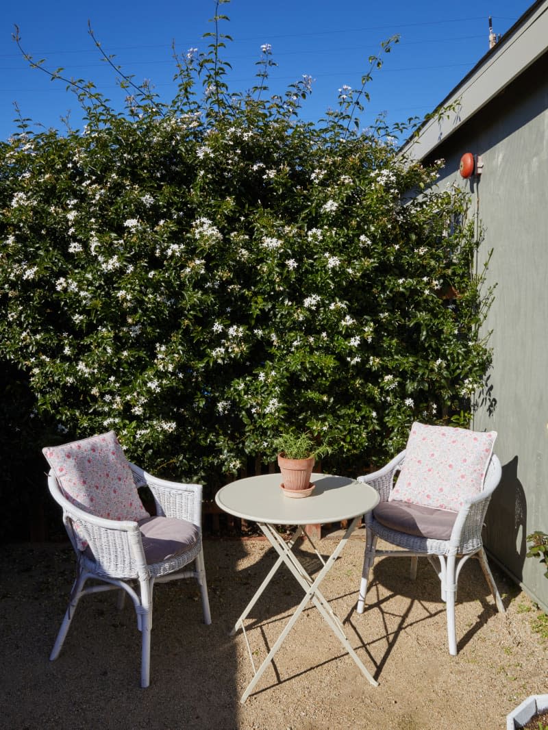 An outdoor sitting area with chairs and a table.