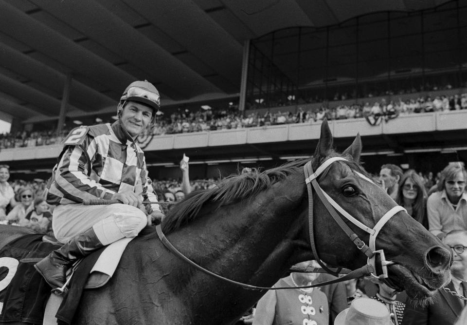 FILE - Jockey Ron Turcotte walks Secretariat towards the winners circle after they captured the Triple Crown by winning the Belmont Stakes at Belmont Park in Elmont, N.Y., June 9, 1973. (AP Photo/File)