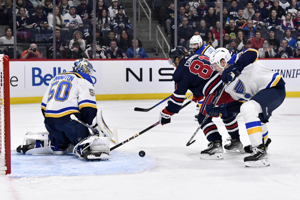 St. Louis Blues goaltender Jordan Binnington (50) makes a save on Winnipeg Jets' Kyle Connor (81) during the second period of an NHL hockey game Tuesday, Oct. 24. 2023, in Winnipeg, Manitoba. (Fred Greenslade/The Canadian Press via AP)