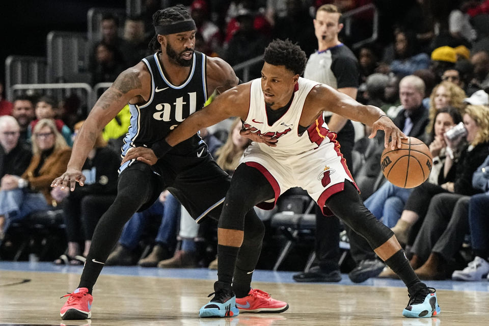 Miami Heat guard Kyle Lowry (7) moves the ball against Atlanta Hawks guard Wesley Matthews (32) during the first half of an NBA basketball game, Saturday, Nov. 11, 2023, in Atlanta. (AP Photo/Mike Stewart)