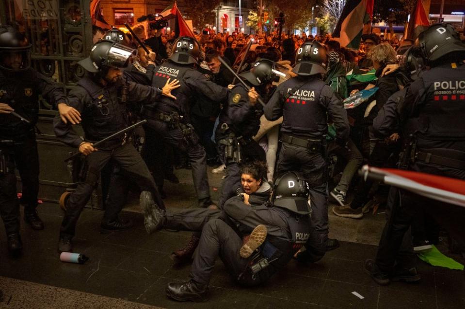 Police officers clash with pro-Palestinian demonstrators as they try to enter a train station in Barcelona, Spain, on Nov. 11. <span class="copyright">Emilio Morenatti—AP</span>