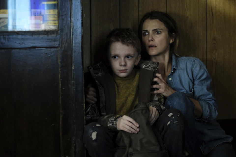 This image released by Searchlight Pictures shows Jeremy T. Thomas, left, and Keri Russell in a scene from "Antlers." (Kimberly French/Searchlight Pictures via AP)