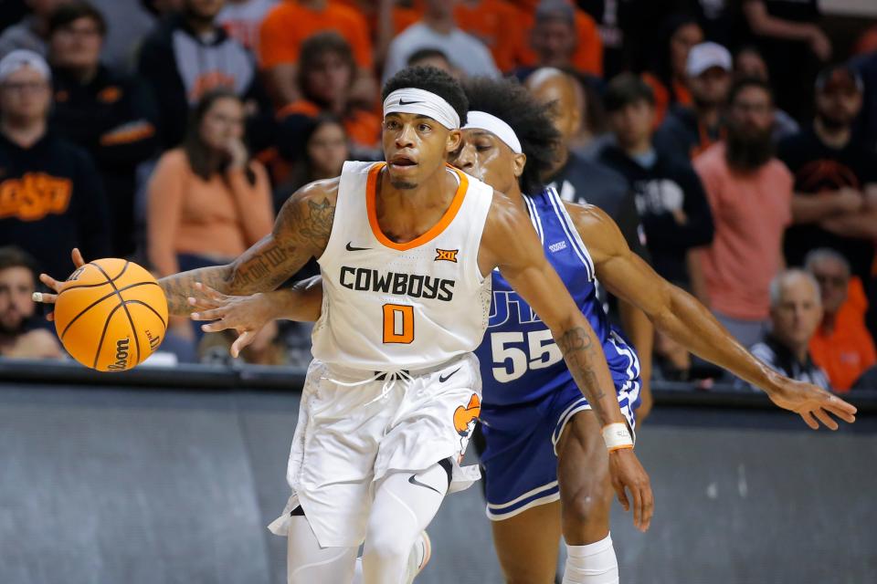 Oklahoma State guard Avery Anderson III (0) goes past Texas-Arlington guard Marion Humphrey (55) during a men's college basketball game between the Oklahoma State Cowboys (OSU) and UT Arlington at Gallagher-Iba Arena in Stillwater, Okla., Monday, Nov. 7, 2022.