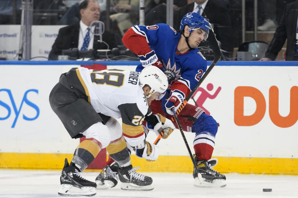 Vegas Golden Knights left wing William Carrier (28) competesfor the puck against New York Rangers left wing Chris Kreider (20) during the first period of an NHL hockey game Friday, Jan. 27, 2023, at Madison Square Garden in New York. (AP Photo/Mary Altaffer)