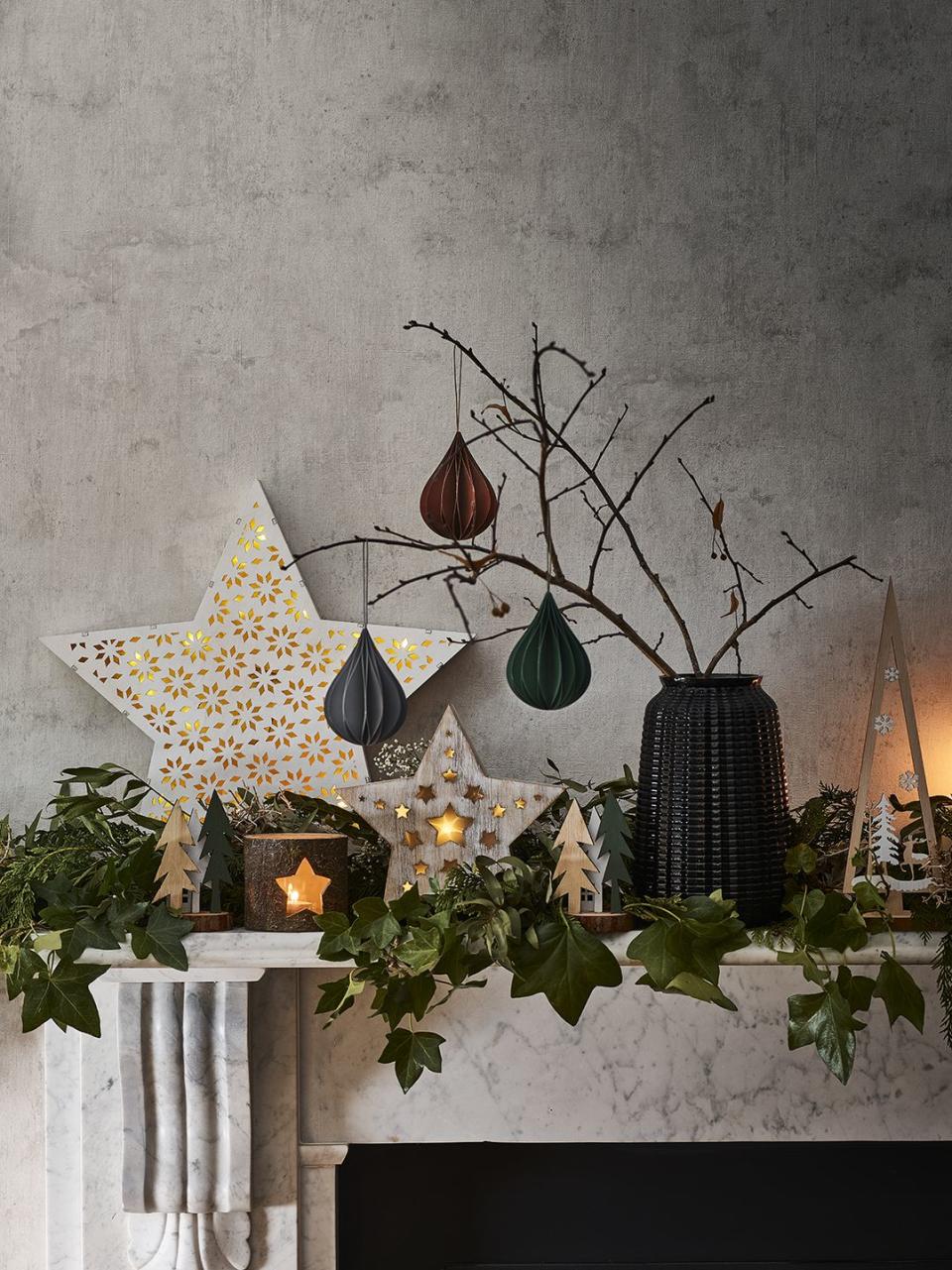 <p><a href="https://www.housebeautiful.com/uk/lifestyle/shopping/g29585316/christmas-garland/" rel="nofollow noopener" target="_blank" data-ylk="slk:Garlands;elm:context_link;itc:0;sec:content-canvas" class="link ">Garlands</a> are a traditional decoration for fireplaces, but that doesn't mean you can't play around with adding other decorations. Dress your mantelpiece to impress this Christmas with mini <a href="https://www.housebeautiful.com/uk/lifestyle/shopping/g29471908/twig-christmas-tree/" rel="nofollow noopener" target="_blank" data-ylk="slk:twig trees;elm:context_link;itc:0;sec:content-canvas" class="link ">twig trees</a> (or simply twigs from the garden), glowing tea lights, fresh eucalyptus, paper decorations and your favourite figurines. </p><p><strong>READ MORE</strong>: <a href="https://www.housebeautiful.com/uk/lifestyle/shopping/g29585316/christmas-garland/" rel="nofollow noopener" target="_blank" data-ylk="slk:26 Christmas garlands to buy for your home;elm:context_link;itc:0;sec:content-canvas" class="link ">26 Christmas garlands to buy for your home</a></p>