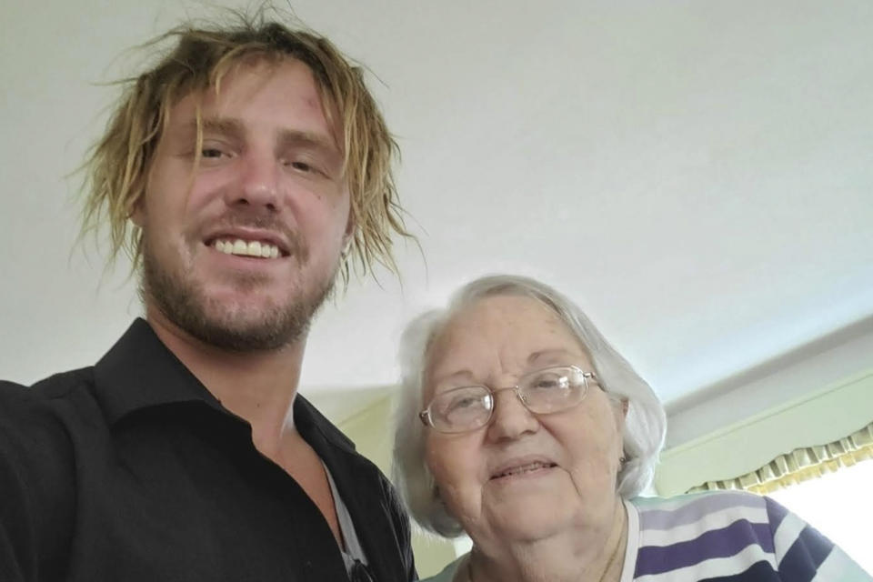 This undated photo provided by April Rudolph shows her brother, Craig Markgraff Jr., left, with Patsy Houry, his grandmother. The body of Markgraff Jr. was found near his home in Hardee County, Fla., six days after Hurricane Ian struck the state's Gulf Coast, Wednesday, Sept. 28, 2022, causing a massive storm search along the coastline and massive flooding throughout the central part of the state. Markgraff Jr. was last seen clinging to a tree as flood waters rose near his Zolfo Springs, Fla., home. The medical examiner said he drowned. Markgraff Jr. is one of 92 deaths from Hurricane Ian in Florida. (April Rudolph via AP)