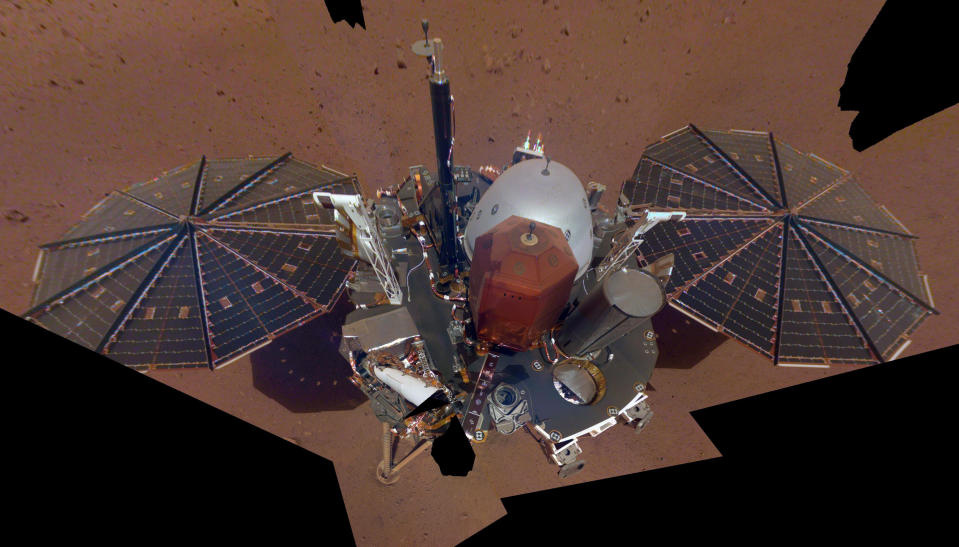 FILE - This Dec. 6, 2018 image made available by NASA shows the InSight lander. The scene was assembled from 11 photos taken using its robotic arm. The spacecraft is losing power because of all the dust that's accumulated on its solar panels. NASA said Tuesday, May 17, 2022, it will keep using the spacecraft's seismometer to detect marsquakes until its power peters out. Officials expect operations to cease in July, almost four years after InSight's arrival at Mars. (NASA via AP, File)