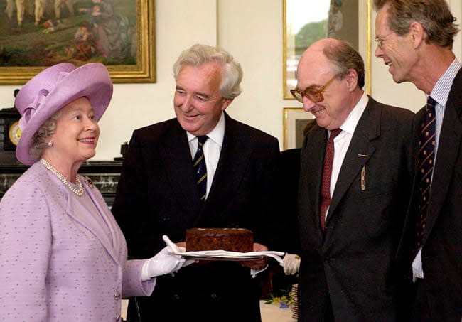 the queen looks delighted with a chocolate cake