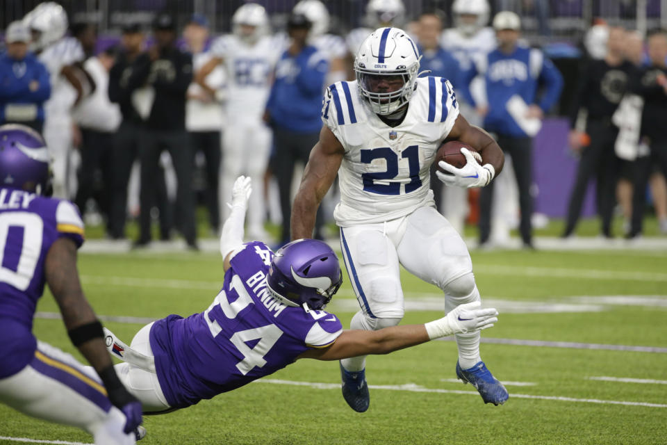 Indianapolis Colts running back Zack Moss (21) runs from Minnesota Vikings safety Camryn Bynum (24) during the first half of an NFL football game, Saturday, Dec. 17, 2022, in Minneapolis. (AP Photo/Andy Clayton-King)