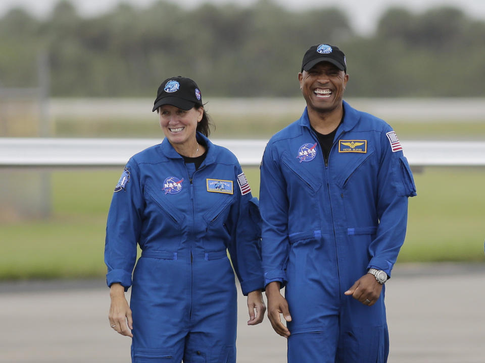 NASA Astronauts Shannon Walker, left, and Victor Glover walk from their airplane after arriving at the Kennedy Space Center, Sunday, Nov. 8, 2020, in Cape Canaveral, Fla. Four astronauts will fly on the SpaceX Crew-1 mission to the International Space Station scheduled for launch on Nov. 14, 2020. (AP Photo/Terry Renna)