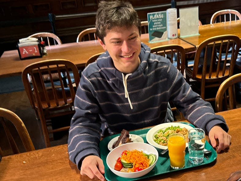 Ezekiel Wells sitting in front of his harvard meal