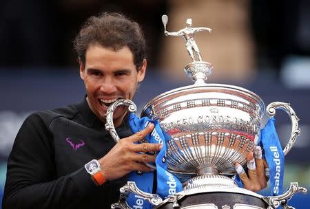 Tennis - Barcelona Open Final - Rafael Nadal of Spain v Dominic Thiem of Austria - Real Club de Tenis Barcelona, Spain - 30/04/17 - Rafael Nadal bites the trophy. REUTERS/Albert Gea