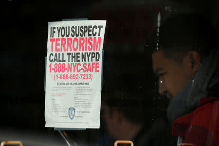 A sign is seen on a window of a building nearby a home in the Brooklyn borough of New York City while Police investigate an earlier incident at the New York Port Authority Bus Terminal in Manhattan where there was an explosion, New York, U.S., December 11, 2017. REUTERS/Lucas Jackson