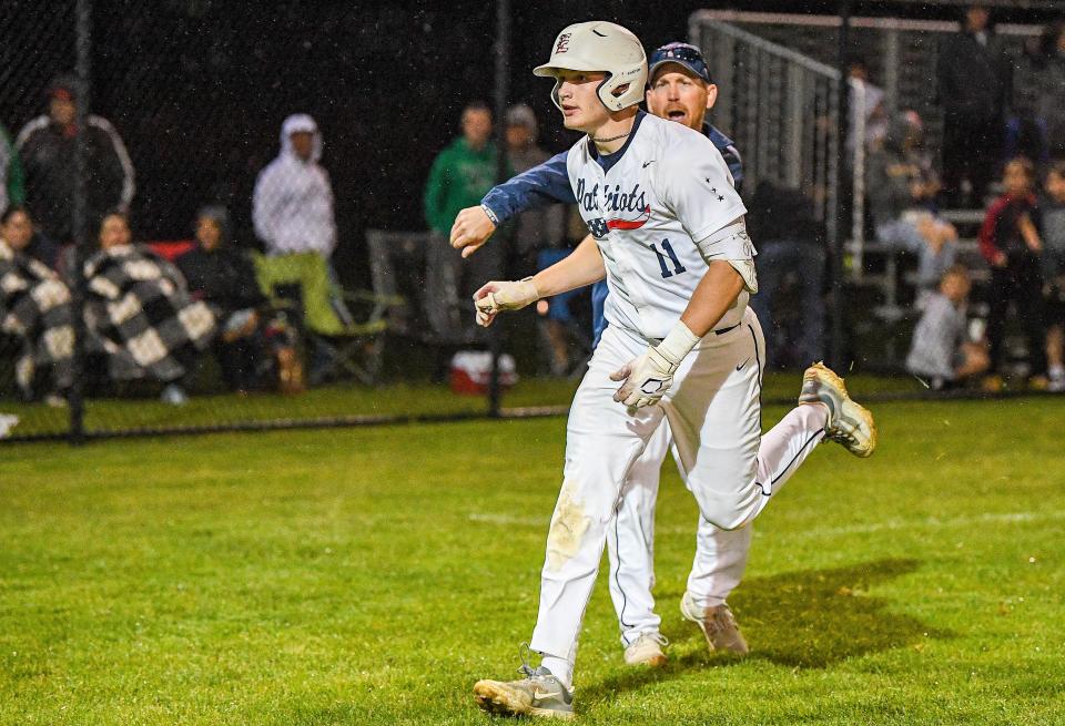 Central Bucks East junior Chase Harlan rounds third base and passes head coach Kyle Dennis after hitting a walk-off two-run homer to beat Central Bucks West 4-3 in May 2023.
