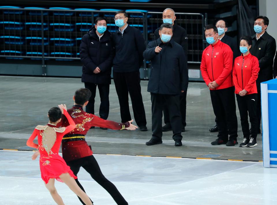 Chinese President Xi Jinping, center, watches skaters perform during a tour of venues and preparations for the 2022 Beijing Winter Olympics at the Capital Gymnasium in Beijing.