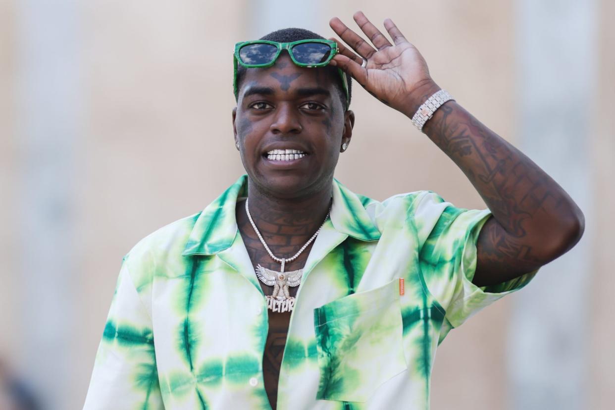 PARIS, FRANCE - JUNE 23: Kodak Black seen wearing a green Bottega Veneta sunglasses, a large diamond necklace, a green/white batik blouse shirt from Nahmias and a green pattern pants, outside the Nahmias show, during Paris Fashion Week - Menswear Spring/Summer 2023 on June 23, 2022 in Paris, France. (Photo by Jeremy Moeller/Getty Images)