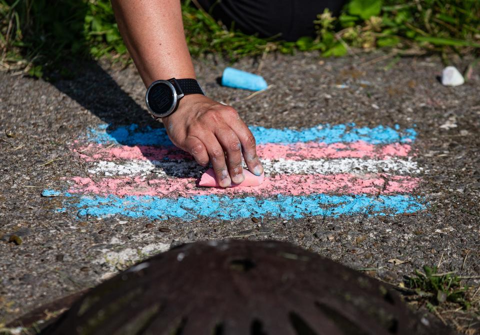 A transgender flag was drawn on a patch of concrete during a rally outside the JCPS VanHoose Center, urging JCPS leaders to fight against SB 150. May 23, 2023