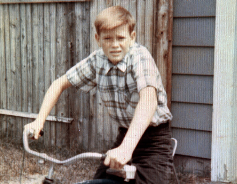 John loved to ride his bike and rebuild engines -- a budding engineer, like his father. / Credit: Evelyn McCabe