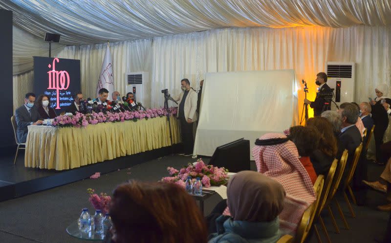 People attend a news conference held by the Jordanian Ministry of Tourism for the two statues that were uncovered by archaeologists in a remote southeastern Jordanian desert in Amman