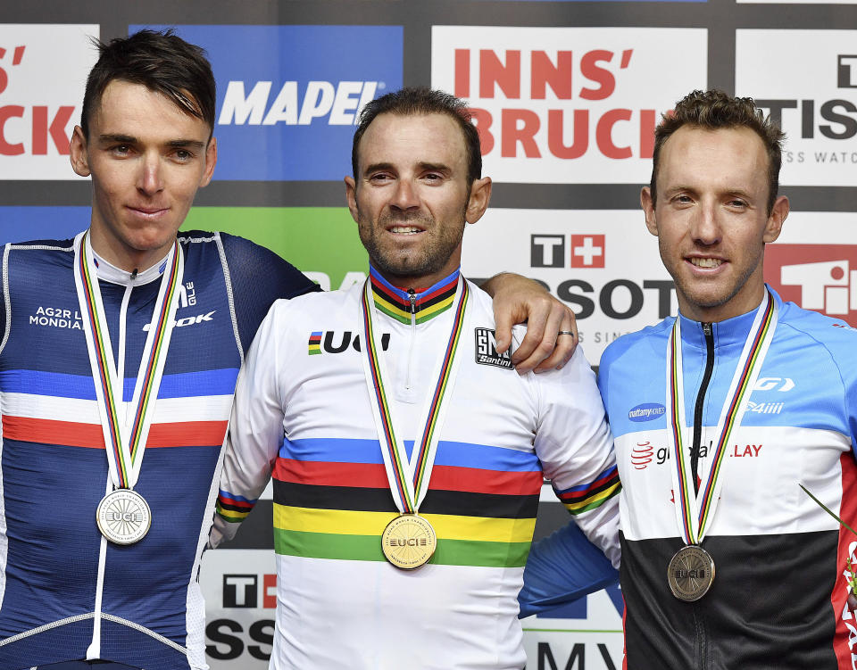 Spain's winner Alejandro Valverde, center, silver medal winner Romain Bardet from France, left, and third place winner Michael Woods from Canada stand on the podium after the men's road race at the Road Cycling World Championships in Innsbruck, Austria, Sunday, Sept.30, 2018. (AP Photo/Kerstin Joensson)