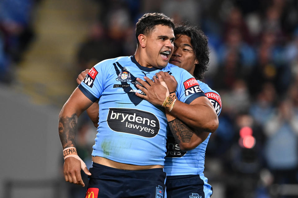 GOLD COAST, AUSTRALIA - JULY 14:  Latrell Mitchell of the Blues celebrates with Brian To'o of the Blues after scoring a try during game three of the 2021 State of Origin Series between the New South Wales Blues and the Queensland Maroons at Cbus Super Stadium on July 14, 2021 in Gold Coast, Australia. (Photo by Bradley Kanaris/Getty Images)