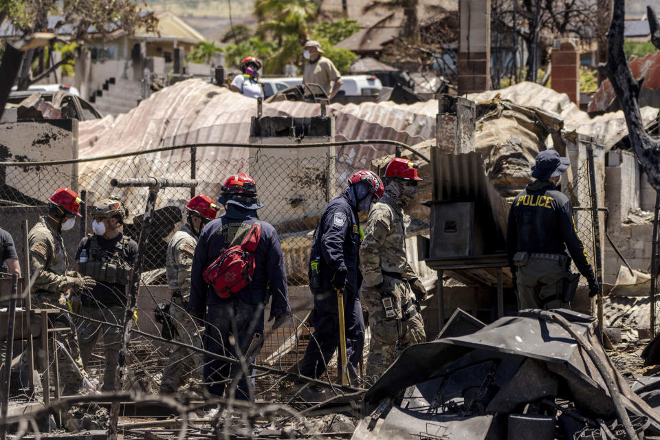 Search and rescue team members work in the area devastated by a wildfire in Lahaina, Hawaii, Thursday, Aug. 17, 2023. The blazes incinerated the historic island community of Lahaina and killed more than 100 people. (AP Photo/Jae C. Hong)