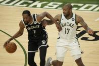 Brooklyn Nets' Kevin Durant tries to drive past Milwaukee Bucks' P.J. Tucker during the second half of Game 4 of the NBA Eastern Conference basketball semifinals game Sunday, June 13, 2021, in Milwaukee. (AP Photo/Morry Gash)