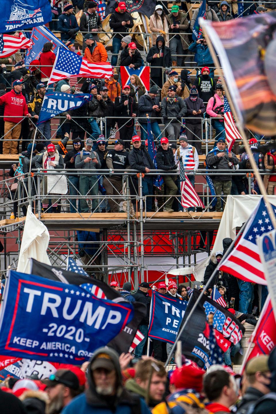 Pro-Trump rioters take over temporary risers built for Joe Biden's inauguration at the U.S. Capitol on Jan. 6.