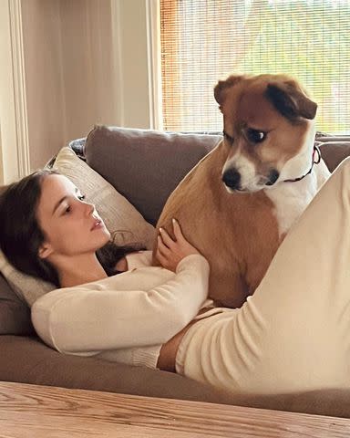 <p>Alba Baptista/Instagram</p> Alba Baptista lounges with Dodger the dog.