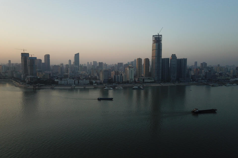 This aerial photo shows Wuhan skyline, China, Thursday evening, Jan. 14, 2021. A global team of researchers arrived Thursday in the Chinese city where the coronavirus pandemic was first detected to conduct a politically sensitive investigation into its origins amid uncertainty about whether Beijing might try to prevent embarrassing discoveries. (AP Photo/Samuel McNeil)