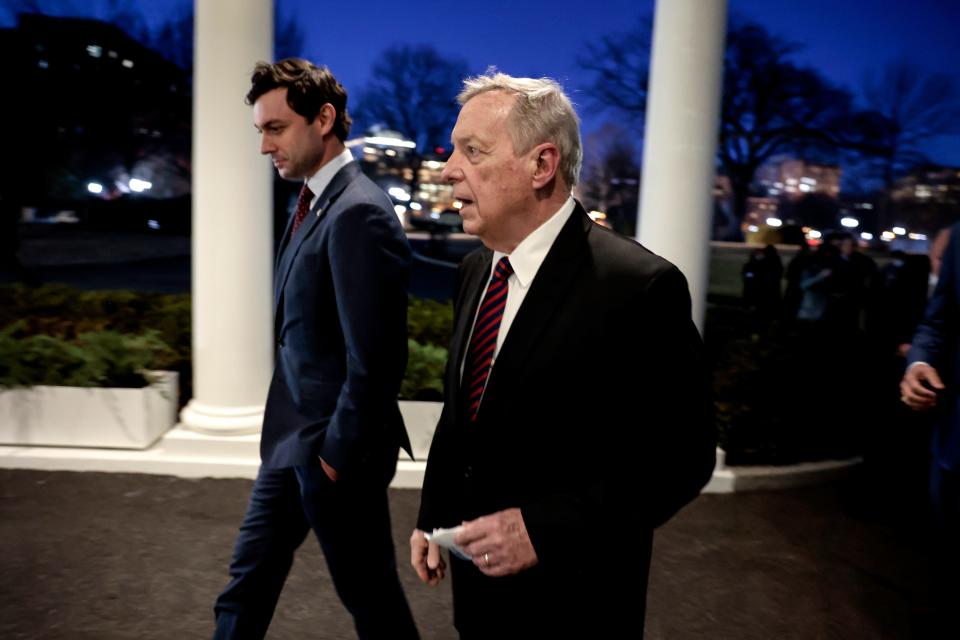 Sen. Jon Ossoff, D-Ga., and Senate Judiciary Chairman Richard Durbin, D-Ill., walk back towards the West Wing of the White House after speaking with reporters about their meeting with President Joe Biden on Feb. 10.