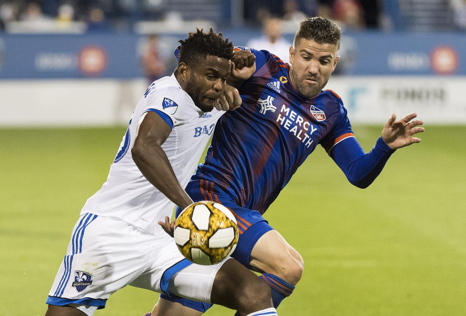 Montreal Impact's Orji Okwonkwo, left, challenges FC Cincinnati's Greg Garza during the second half of an MLS soccer match Saturday, Sept. 14, 2019, in Montreal. (Graham Hughes/The Canadian Press via AP)