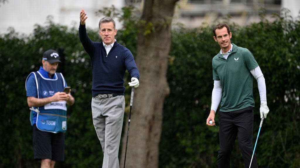 Anton Du Beke and Sir Andy Murray place golf on an overcast day. 