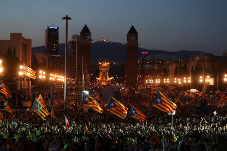 People wave Esteladas (Catalan separatist flags) as they attend a closing rally in favour of the banned October 1 independence referendum in Barcelona, Spain, September 29, 2017. REUTERS/Susana Vera