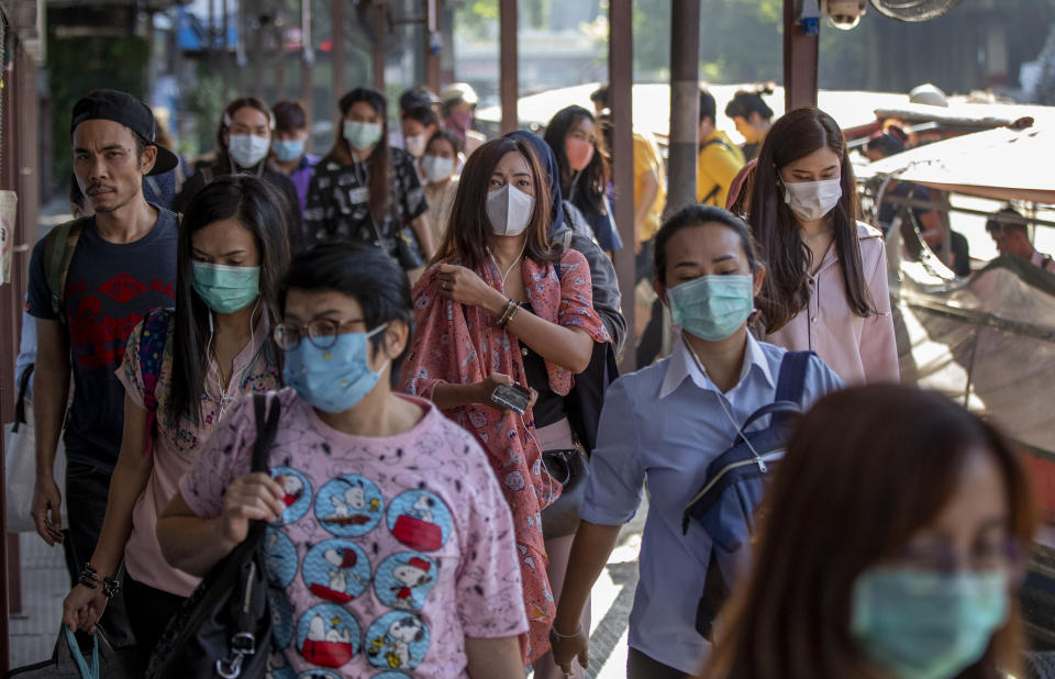 Boat passengers on a jetty wear face masks in Bangkok, Thailand, Tuesday, Jan. 28, 2020 to protect themselves from new virus infection. Panic and pollution drive the market for protective face masks, so business is booming in Asia, where fear of the coronavirus from China is straining supplies and helping make mask-wearing the new normal. (AP Photo/Gemunu Amarasinghe)