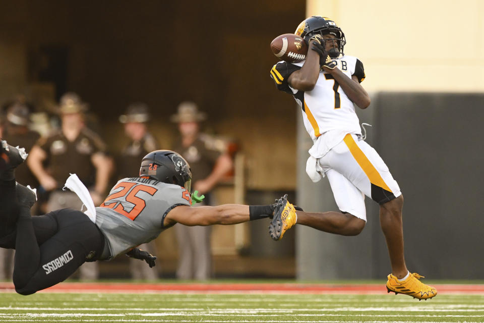 Oklahoma State safety Jason Taylor II (25) reaches out for Arkansas-Pine Bluff wide receiver Daemon Dawkins (7) as he bobbles a catch during the first half of an NCAA college football game, Saturday, Sept. 17, 2022, in Stillwater, Okla. (AP Photo/Brody Schmidt)