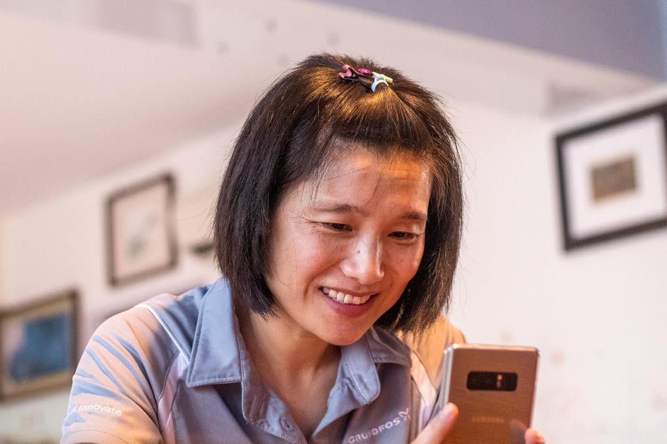 Qu Haiyan chats with her husband and kids over a video call. PHOTO: Dhany Osman/Yahoo News Singapore 