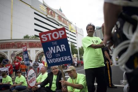 A man is placed in hand cuffs for an act of civil disobedience in blocking traffic to the Trump Taj Mahal in Atlantic City, New Jersey June 17, 2015. REUTERS/Mark Makela