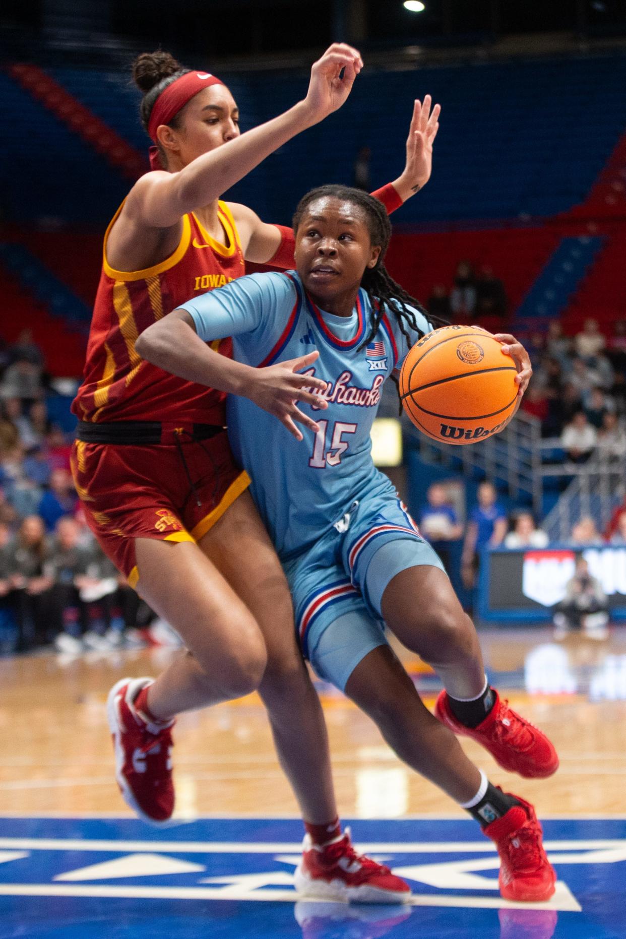 Kansas super-senior guard Zakiyah Franklin (15) drives the ball against Iowa State freshman forward Jalynn Bristow (1) during a Jan. 24, 2024 game inside Allen Fieldhouse.