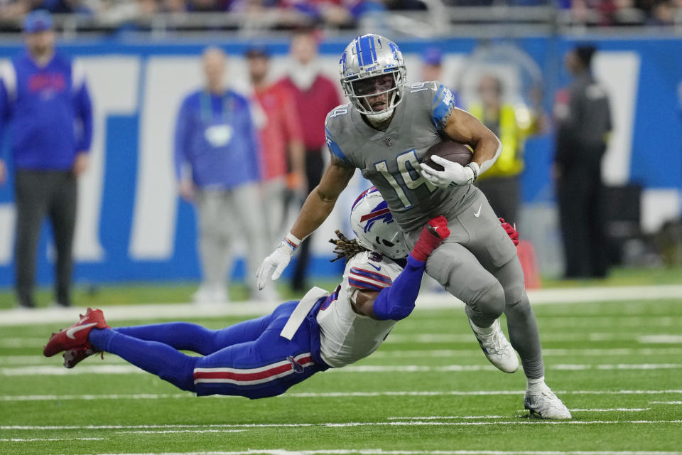 Buffalo Bills safety Damar Hamlin (3) tackles Detroit Lions wide receiver Amon-Ra St. Brown (14) during the second half of an NFL football game, Thursday, Nov. 24, 2022, in Detroit. (AP Photo/Paul Sancya)