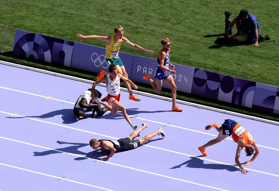 Stewart McSweyn jumps to avoid the bodies in the 5000m race.