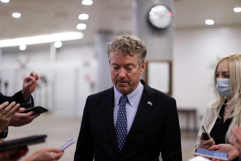 U.S. Senator Paul is trailed by reporters as he arrives to be sworn in for the impeachment trial of former president Trump in the U.S. Capitol in Washington
