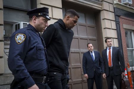 Thabo Sefolosha of the Atlanta Hawks is seen escorted out of the 10th Precinct of the New York Police Department on April 8, 2015. (REUTERS/Andrew Kelly)